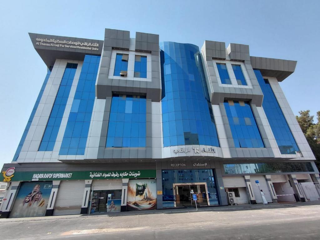 a building with blue windows on a street at Al Thanaa Alraqi Furnished Apartments in Jeddah