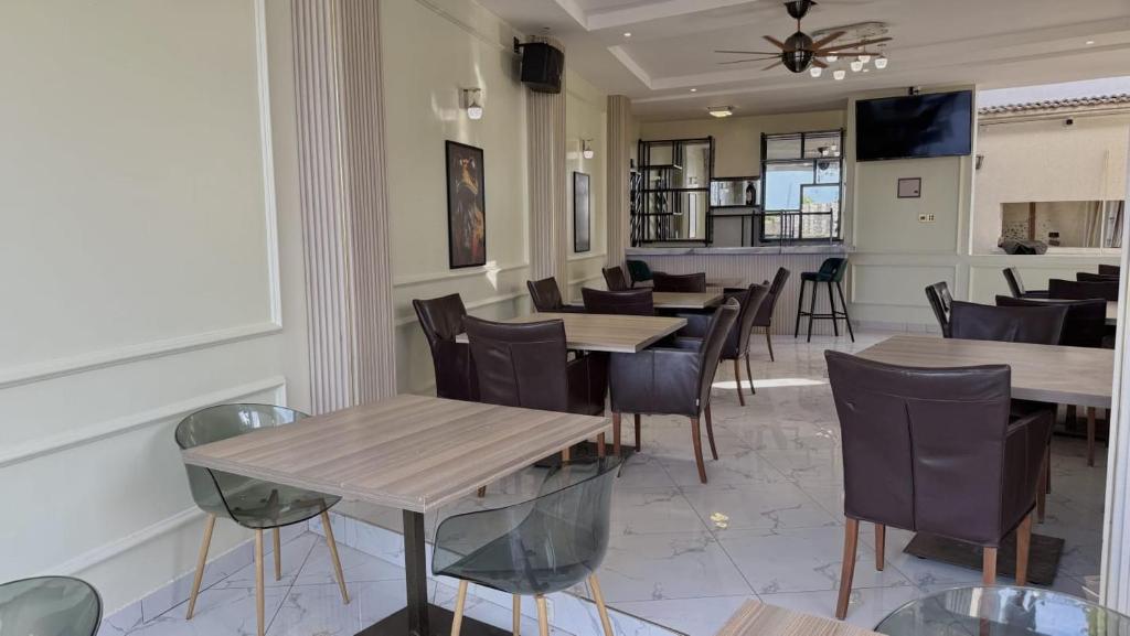 a dining room with wooden tables and chairs at Villa Carino Kilifi Kenya in Kilifi