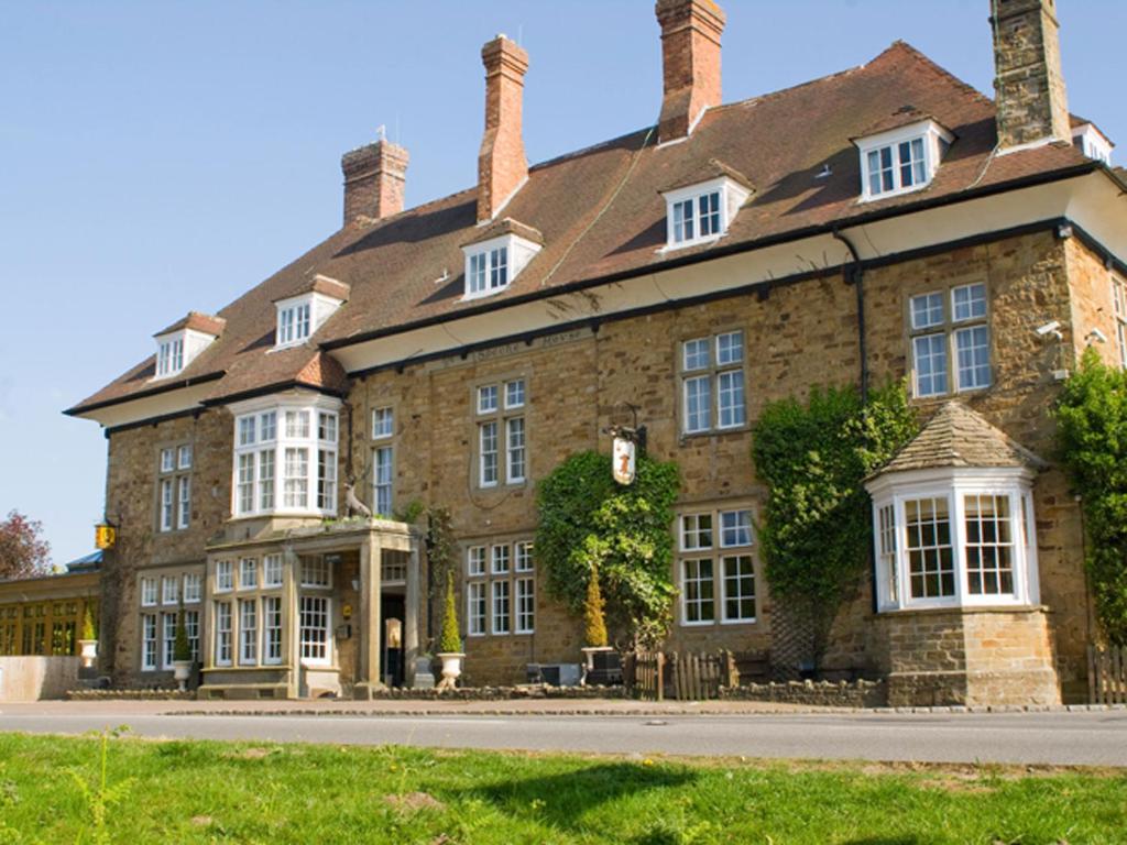 a large stone building with a roof at The Speech House in Coleford