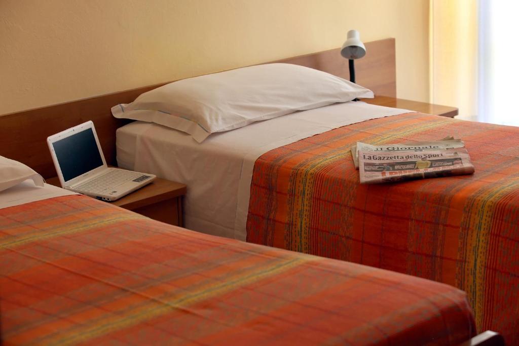 Postel nebo postele na pokoji v ubytování Albergo Centopini