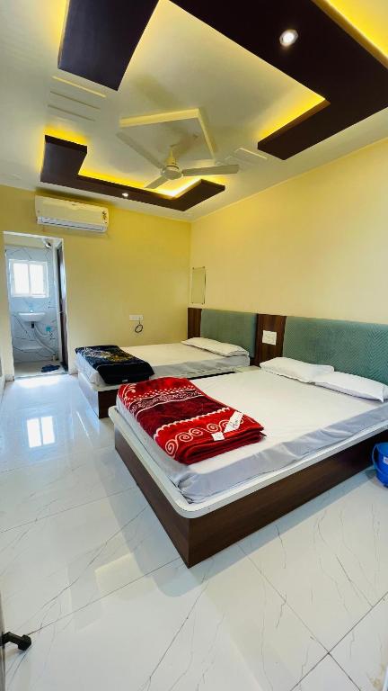 a bedroom with two beds in a room at Maa Rewa Palace in Sānāwad