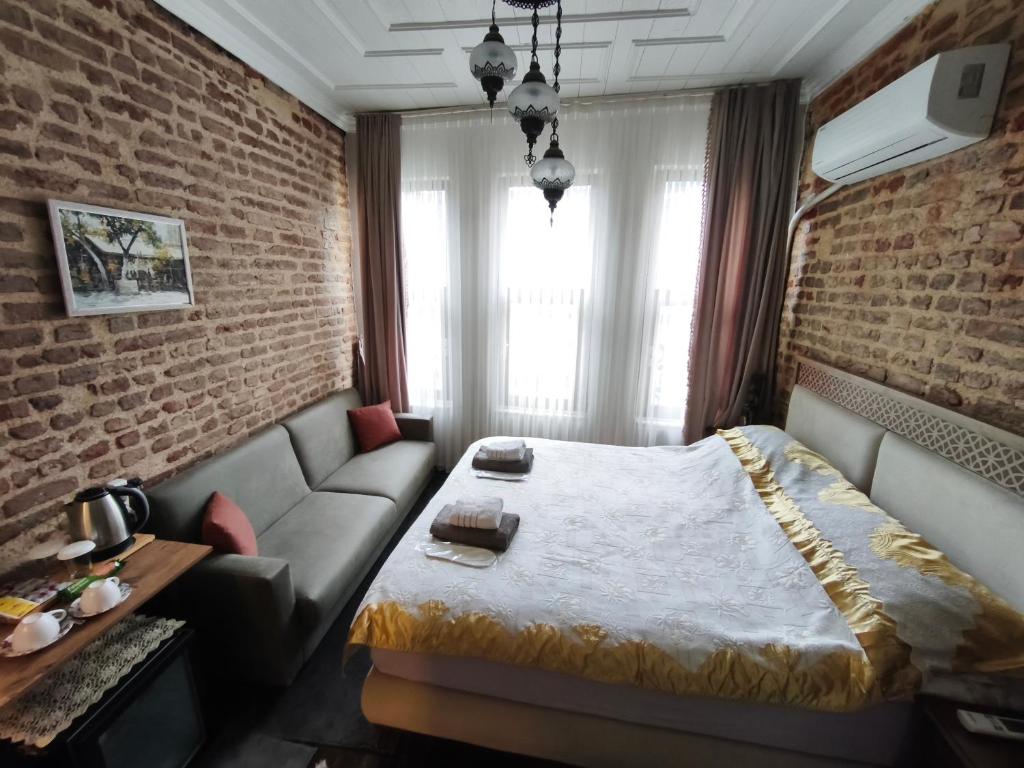 a hotel room with a bed and a couch at Fener sweet in Istanbul