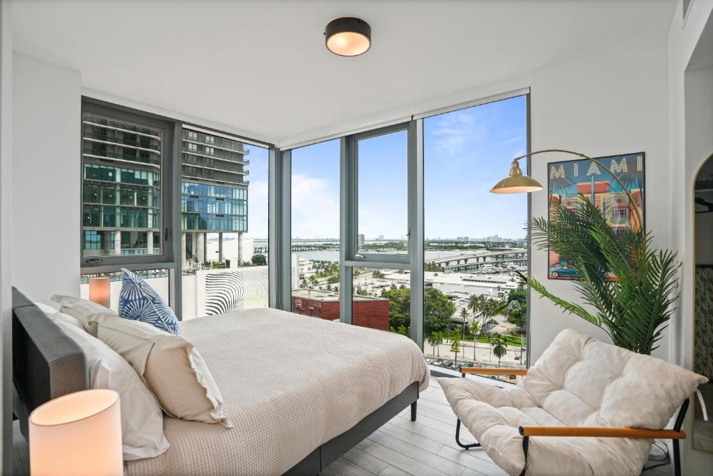 a bedroom with a bed and a large window at Cadenza Miami - Luxury Residences in Miami