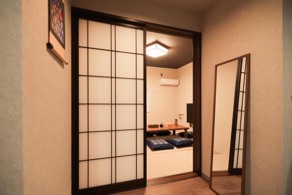 a sliding glass door leading into a room at 朱鷺ノ清102 in Odawara