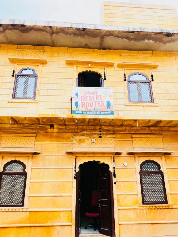 een geel gebouw met een bordje waarop 'speciale kamers' staat bij Hostel Desert Routes in Jaisalmer