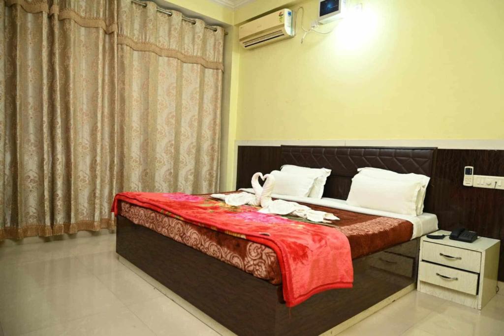 En eller flere senge i et værelse på Homeinn guest house