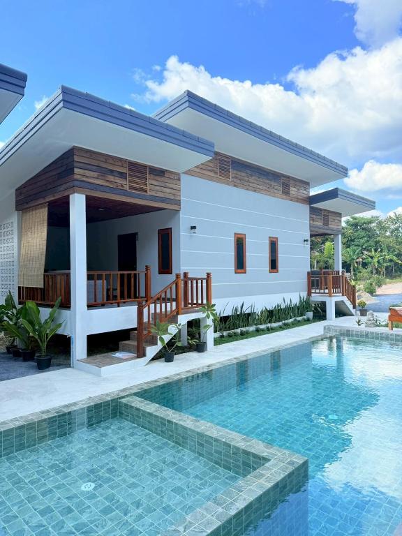 a house with a swimming pool in front of it at BuaSawan Villa Koh Lanta in Ban Not (1)