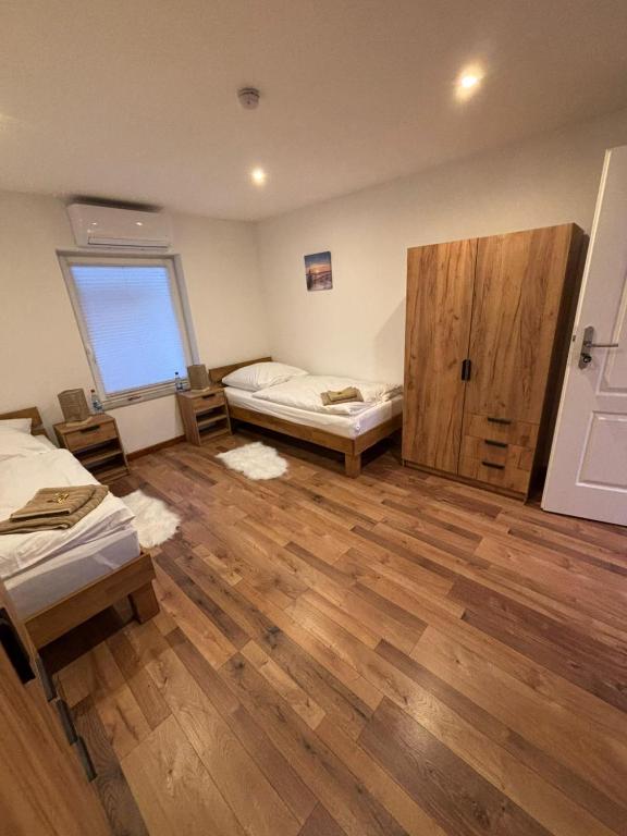 a large room with two beds and a window at Schildetal Apartment 1 in Camin