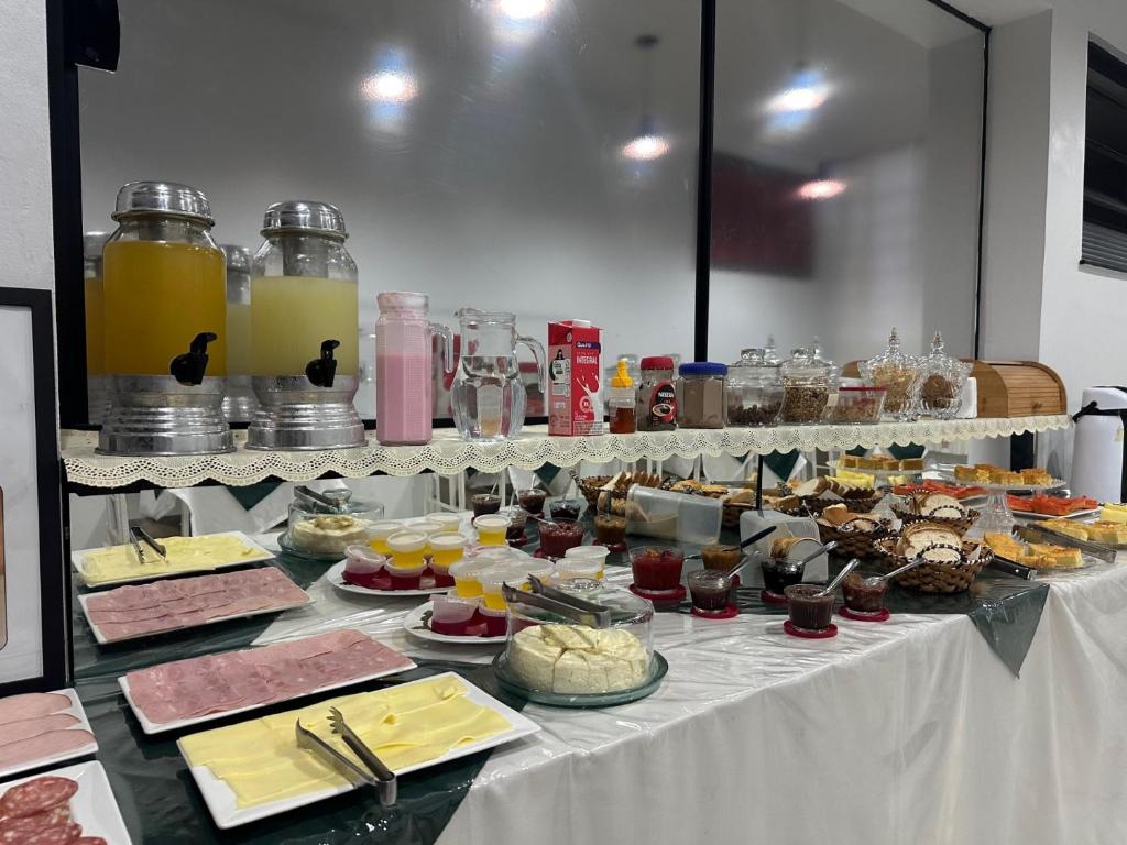 a buffet of food on a table in a room at Hotel Ype de São Carlos in São Carlos