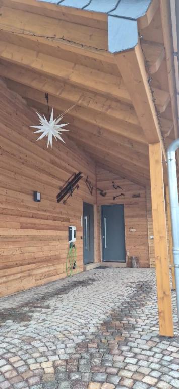 a building with a wooden wall with a ceiling at Schneekopfblick in Oberhof