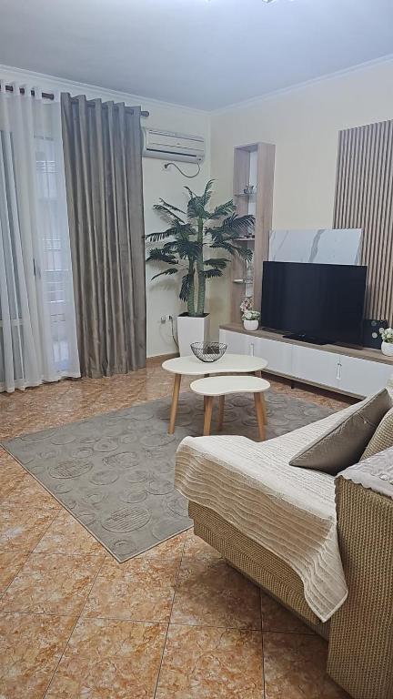 a living room with a couch and a table at Roxy's house in Vlorë