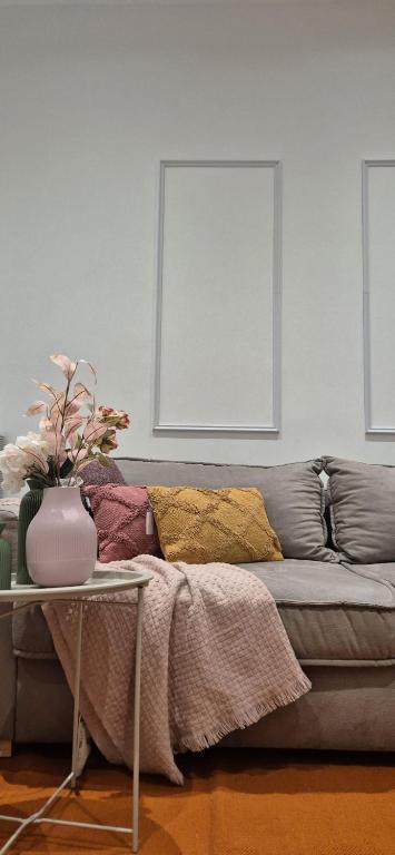 a living room with a couch with pillows on it at RuhREpott Hosting in Recklinghausen