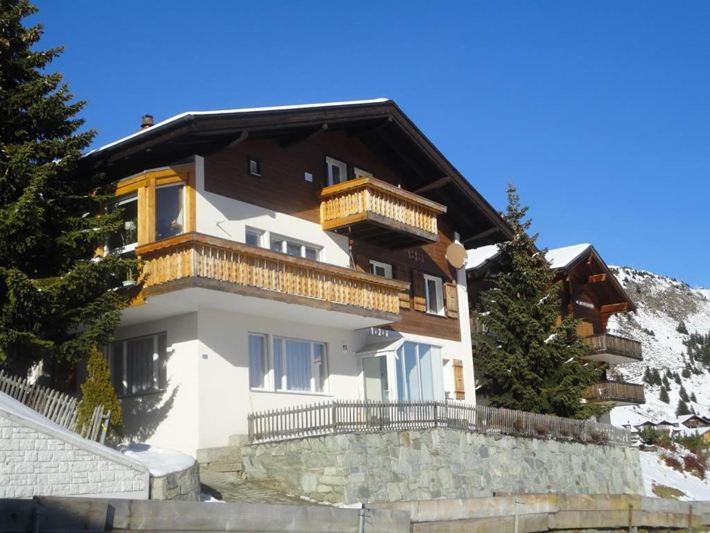 a building on a hill with trees in front of it at Tamara Parterre in Riederalp