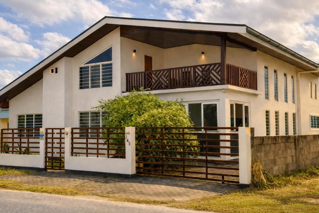a house with a fence in front of it at Maison Meredith in Paramaribo