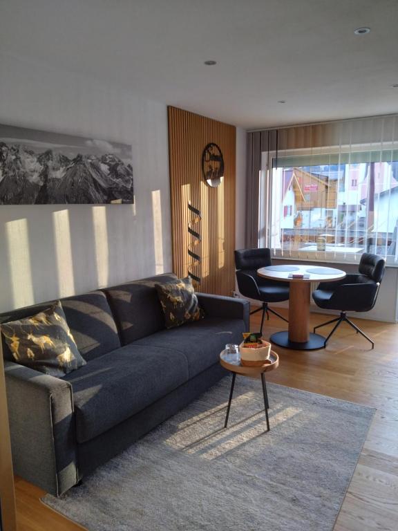 een woonkamer met een bank en een tafel bij Goldstück in Oberstdorf