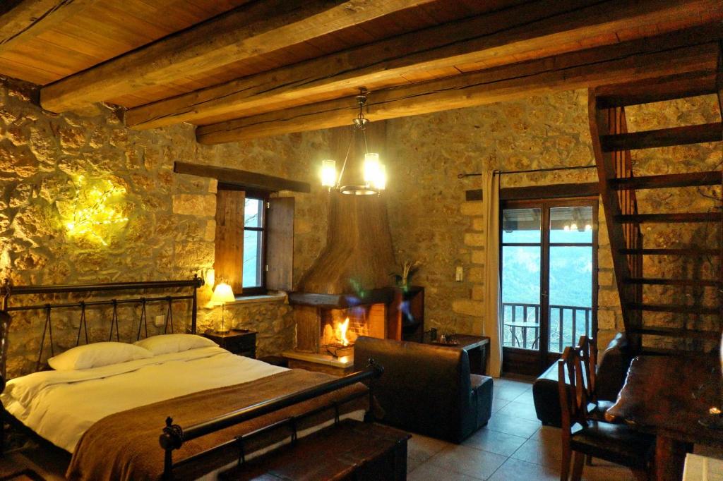 ein Schlafzimmer mit einem Bett in einer Steinmauer in der Unterkunft Ξενώνας Αστερωδή in Karya