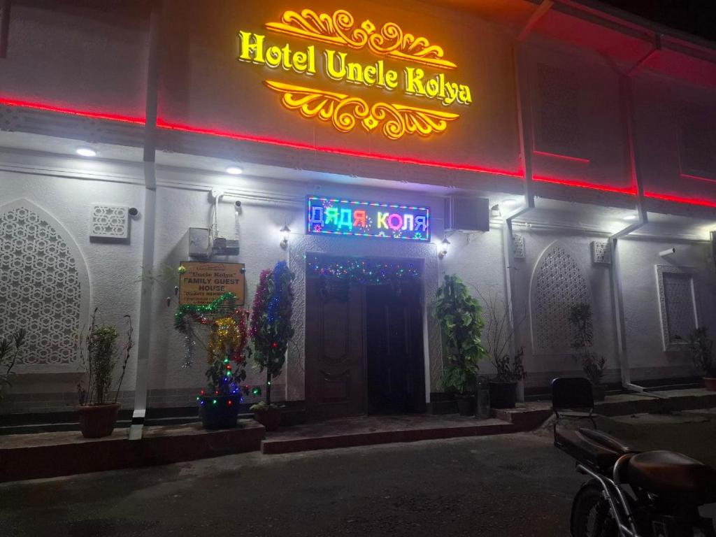 a hotelilage revision sign on the side of a building at Uncle Kolya Hotel str M Azam 39 in Bukhara