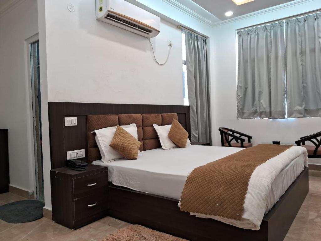 a bedroom with a bed and a air conditioner at The Inspira Hotel Haridwar in Haridwār