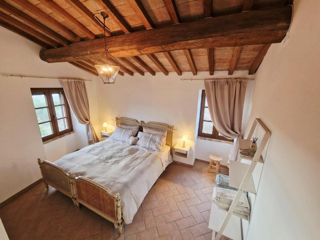 a bedroom with a bed in a room with wooden ceilings at Torre del Tempo in Torgiano