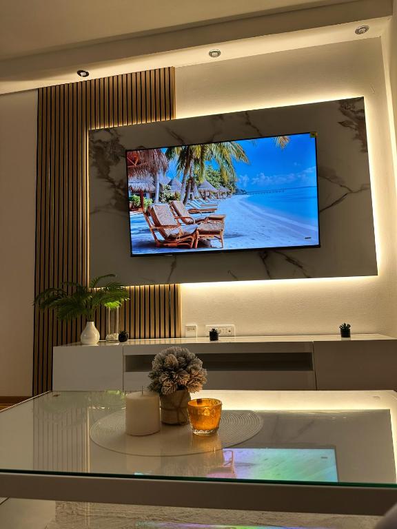 a living room with a tv on a wall at Cetral032 in Čačak