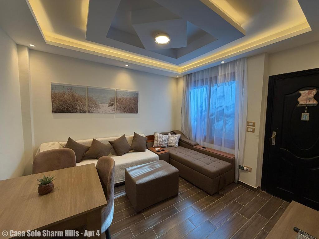 a living room with a couch and a table at Casa Sole Sharm Hills Apt 4 in Sharm El Sheikh