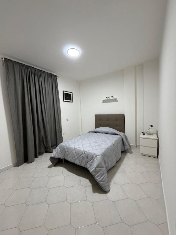 a bedroom with a bed in a white room at B&B Boffa in Buccino
