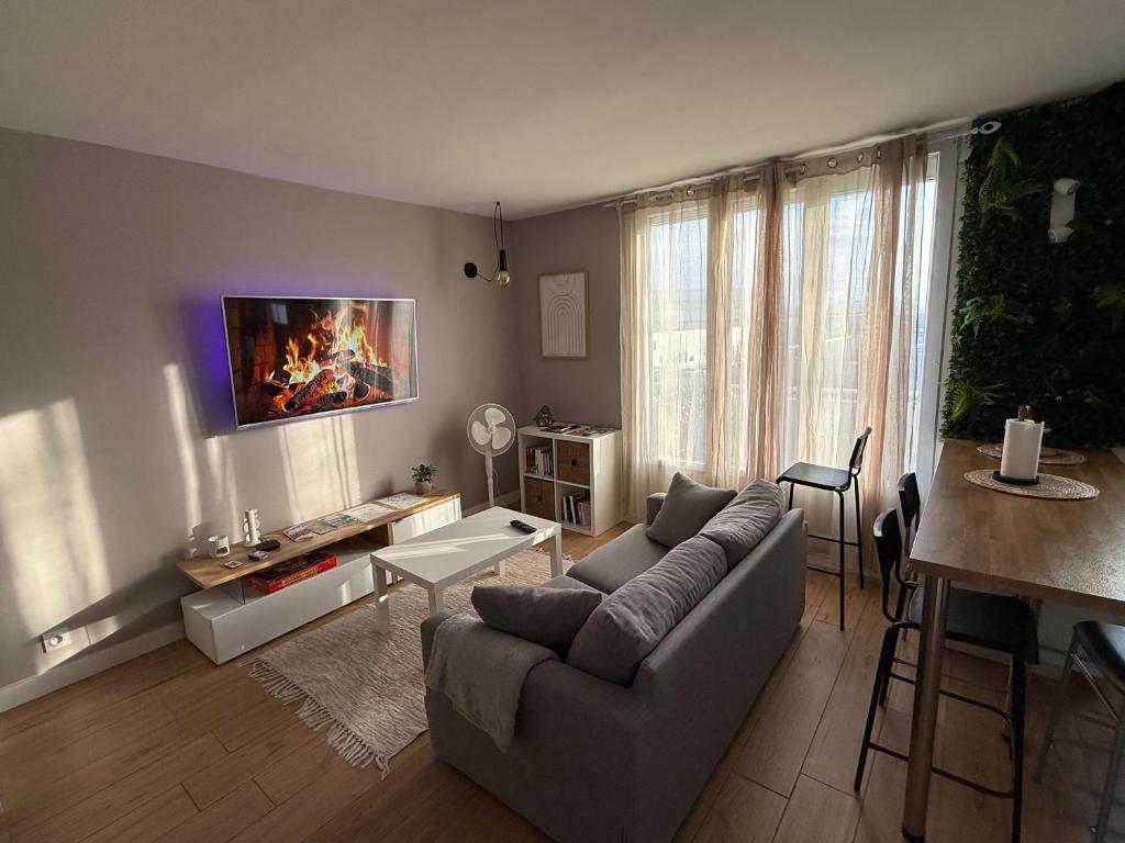 a living room with a couch and a table at LE DUPLEX PANORAMA -Vue Montagne -2 Chambres -Parking Gratuit - CLIM Mobile in Grenoble
