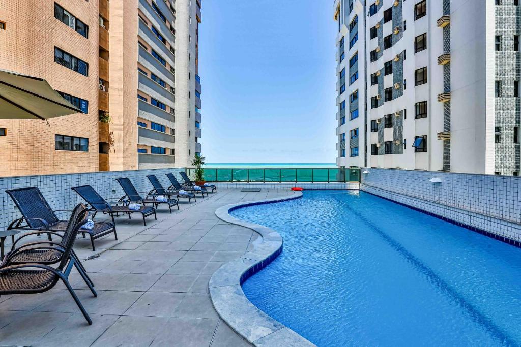 a swimming pool in the middle of a building at BEIRA MAR- FLAT EXECUTIVE in Recife