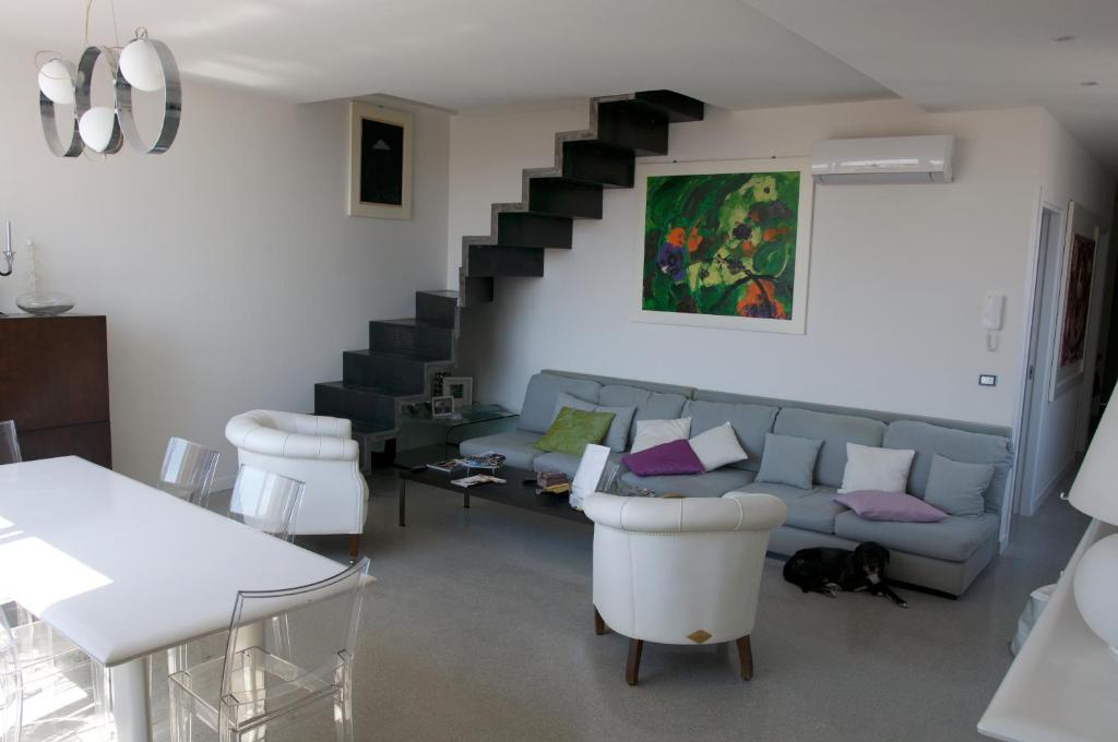 a living room with a couch and a staircase at Casa Maria in Salerno