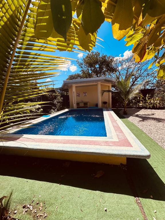 a swimming pool in front of a house at La Laguna in Nosara