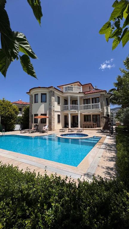 a large house with a large swimming pool at Dalyan Turaman private pool sleeps 10 in Ortaca
