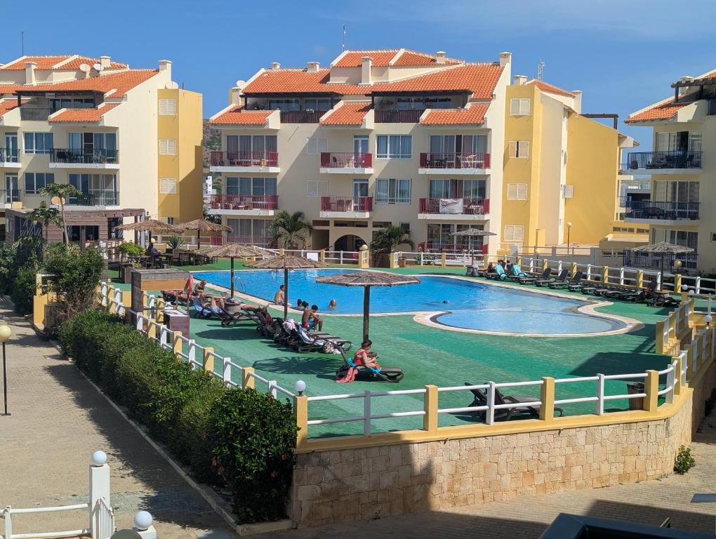a swimming pool at a resort with buildings at Vista Oceano - Boa Vista Island in Sal Rei