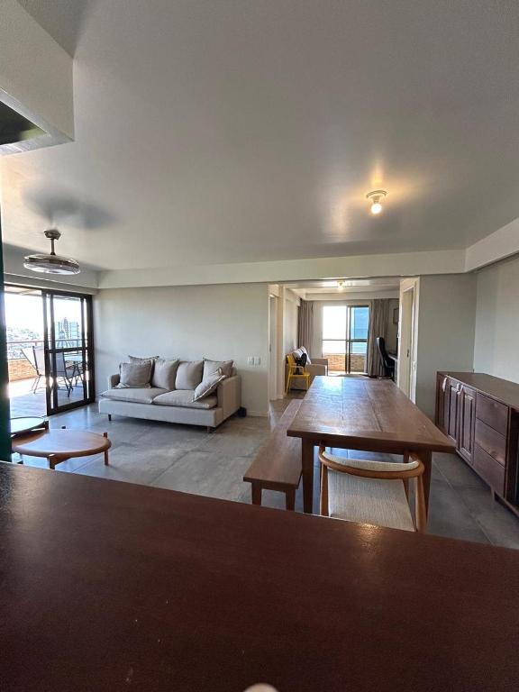 a living room with a couch and a table at Apartamento Outeiro in Ilhéus