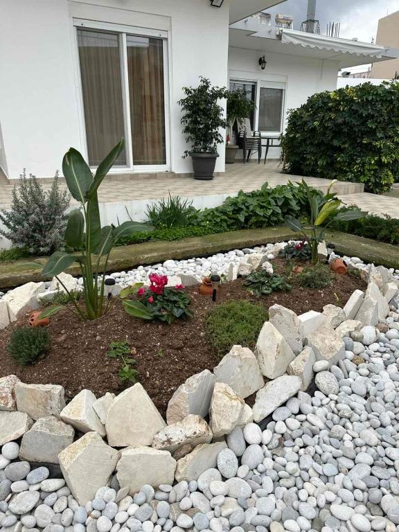 a garden with rocks and plants in front of a house at Ioanna's Home in Émbonas