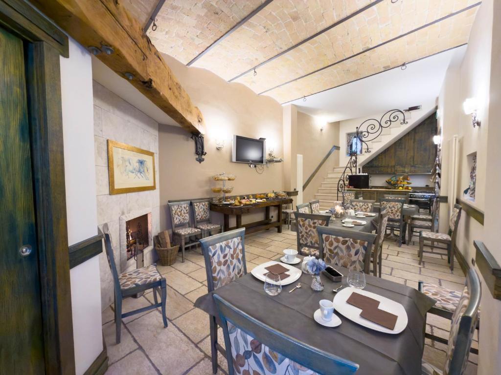 a dining room with a table and chairs and a fireplace at IL Postale in Castel di Sangro