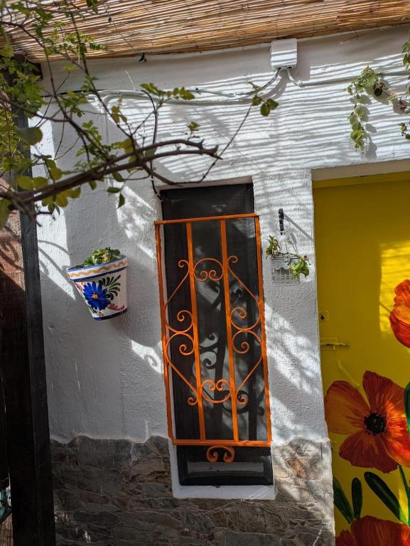 an orange and black light on the side of a building at La Cigarra in Ronda