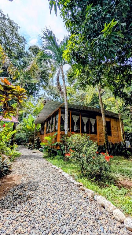 a house with a gravel road in front of it at Arbura in Uvita