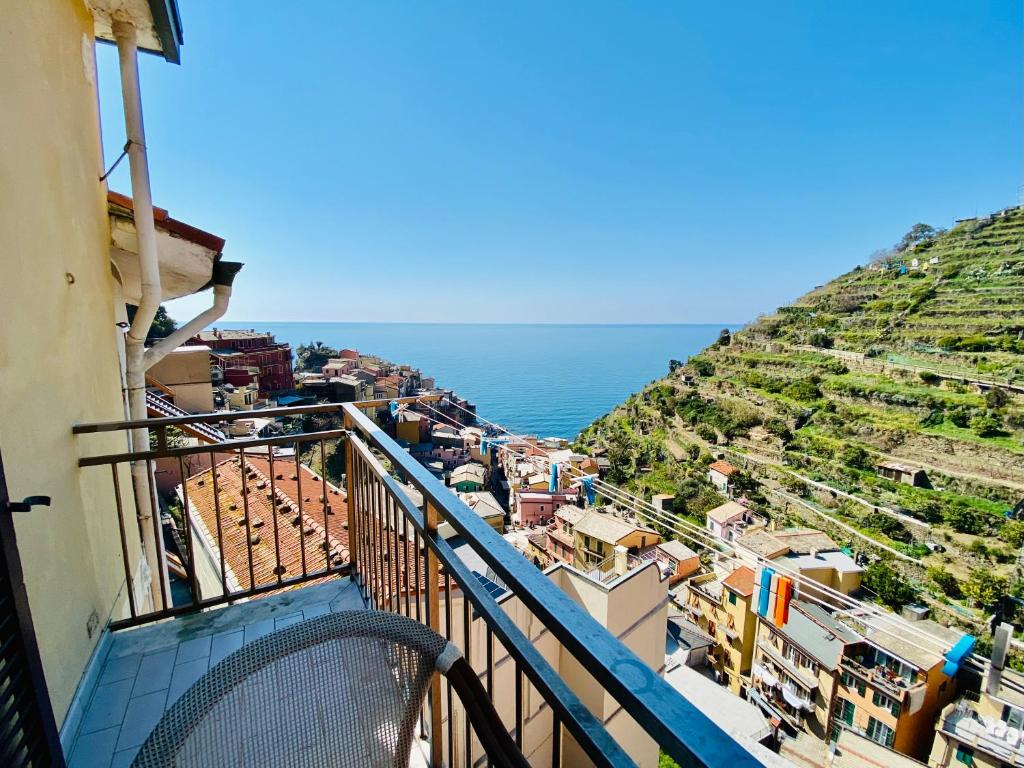 a view from a balcony of a town with the ocean at Giovanni Rooms Manarola in Manarola