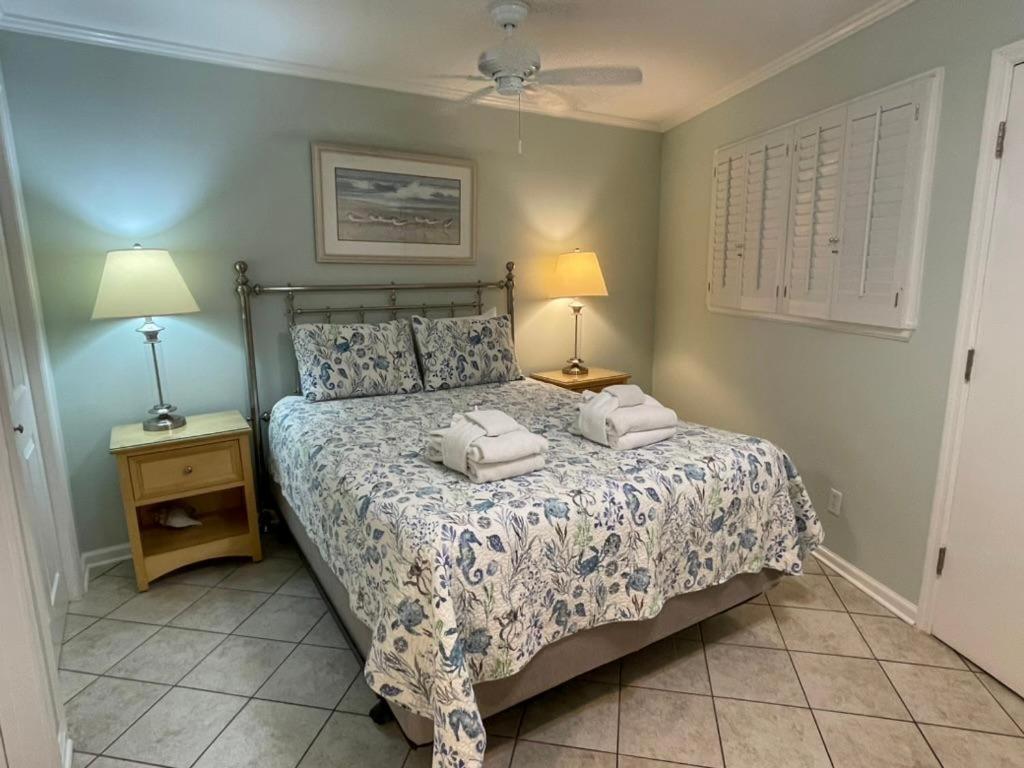 a bedroom with a bed with two towels on it at Seaside 190 in Hilton Head Island
