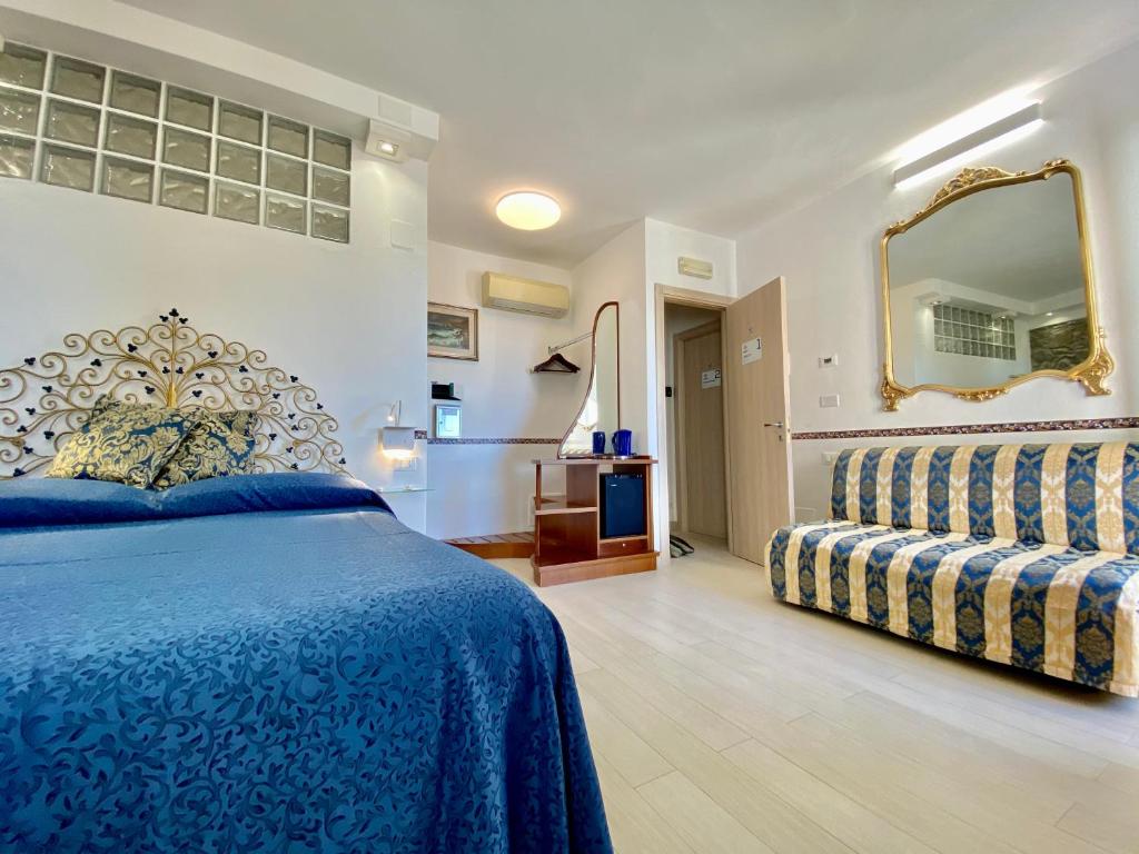 a bedroom with a blue bed and a mirror at Giovanni Rooms Manarola in Manarola