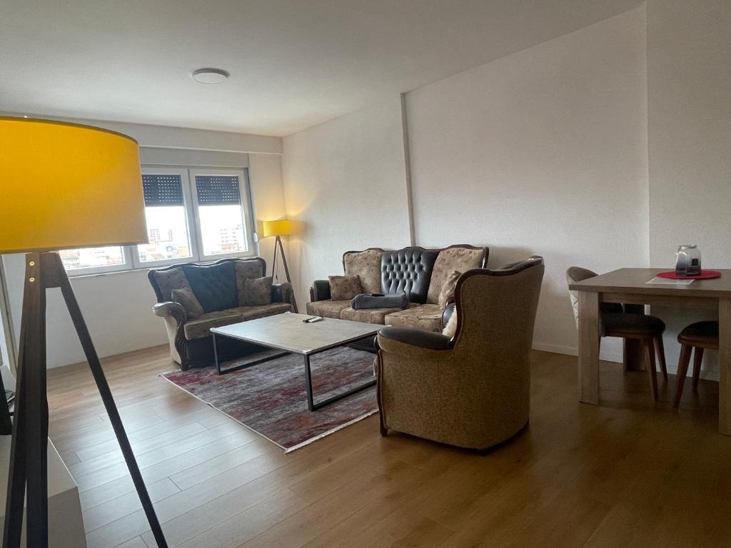 a living room with a couch and a table at Apartament in Ferizaj