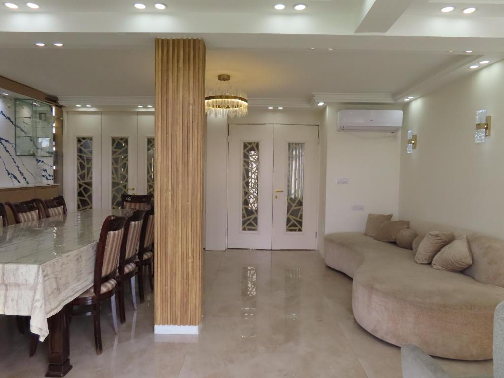 a living room with a couch and a table at Gedera Rental in Gedera
