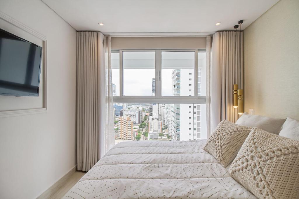 En eller flere senge i et værelse på Encantador Duplex en BOCAGRANDE confort y descanso frente al MAR