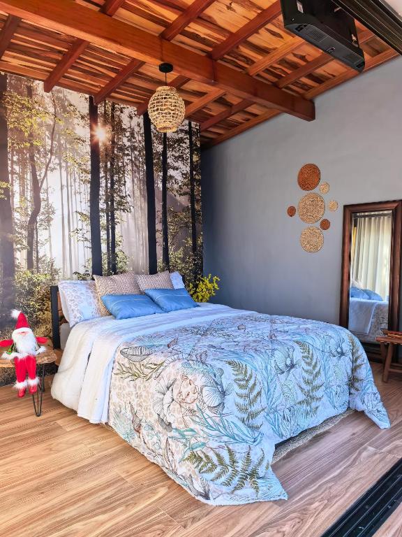 a bedroom with a large bed with a blue comforter at Hospedandote Emuná Chicamocha in Los Santos