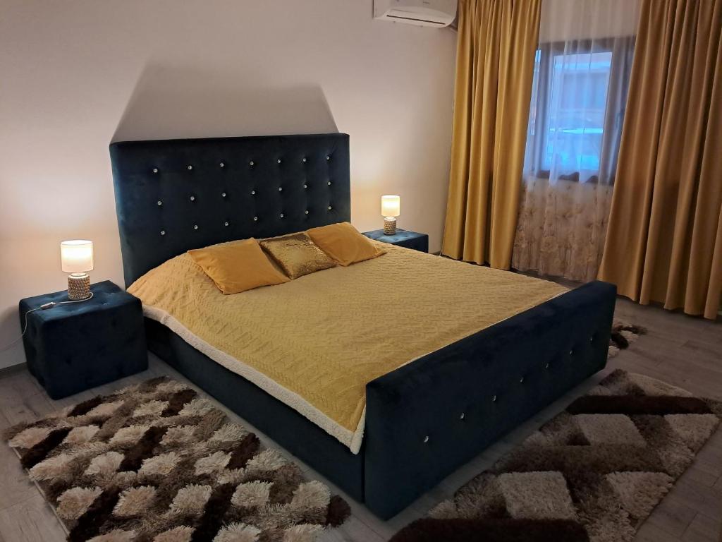 una camera da letto con un letto grande con due comodini di Apartament NECTARIA a Băile Herculane