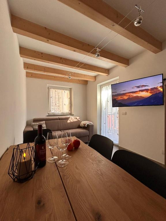 a dining room with a table with wine glasses on it at Alpen Lodge Predazzo in Predazzo