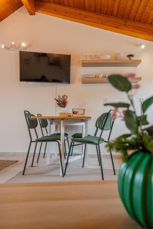 a dining room with a table and four chairs at Rokani Sofita II in Kalavrita