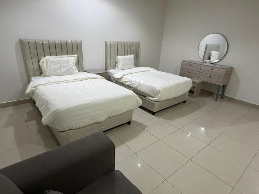 En eller flere senge i et værelse på رايز النسيم للشقق المخدومة