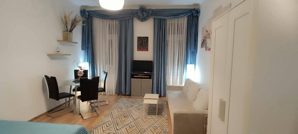 a room with a bed and a desk and a table at Privat Appartment Room Martz Dorf in Vienna