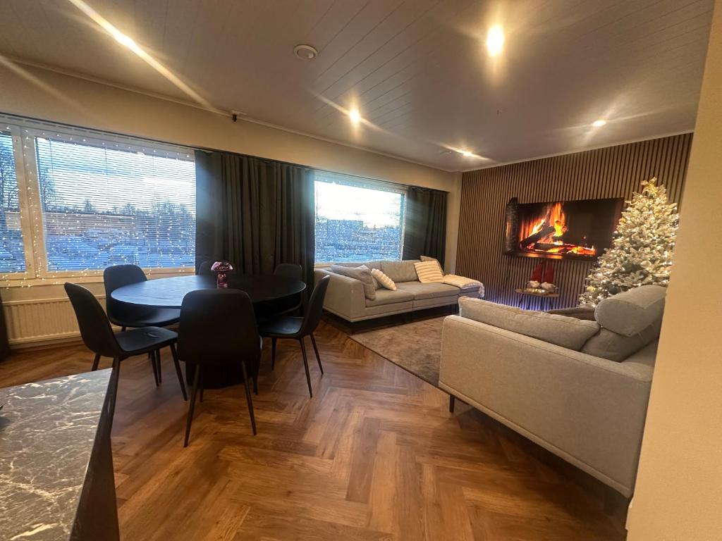 a living room with a couch and a table and a fireplace at Apartment Alakorkalo in Rovaniemi
